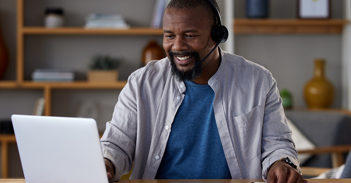  Shot of a mature man using a laptop and headset at home - stock photo