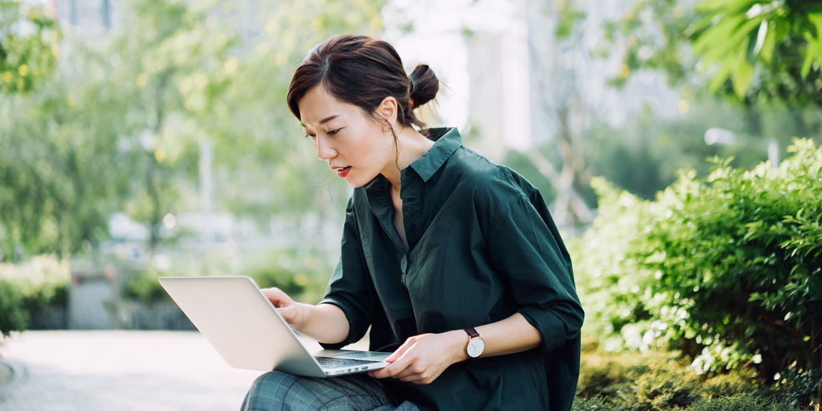 woman using her laptop outdoors