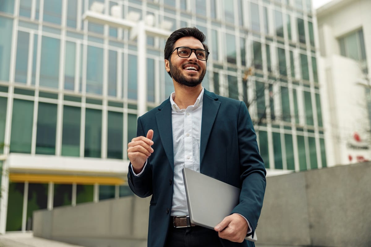 Man in blue suit standing outside office