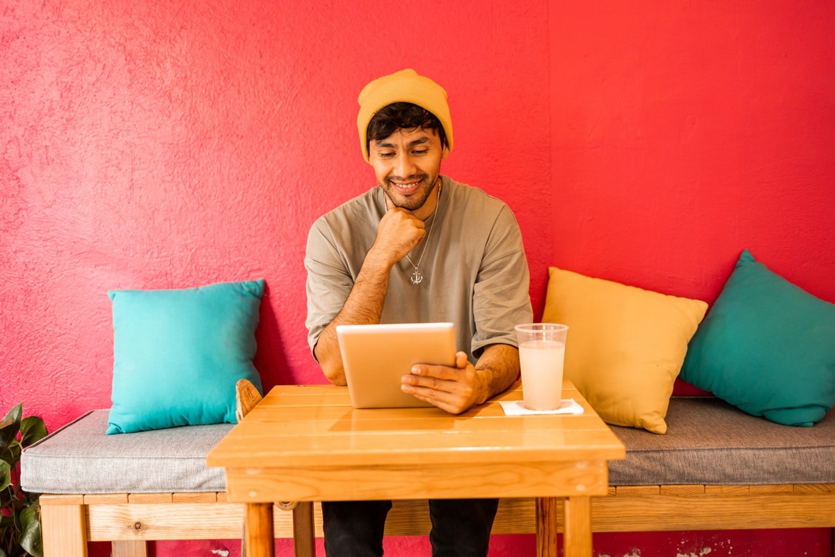 Man in yellow hat sitting at table